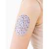 Dexcom G7 adhesive patch with spring design on arm for secure sensor protection.