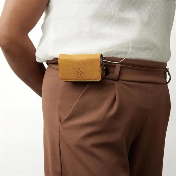 Leather insulin pump bag on a belt for secure diabetes management.