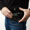 Leather insulin pump holder worn on pants with secure flap open, showcasing stylish design and easy access.