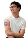 Man wearing Simplera Sensor Patch on arm, colorful design, for Medtronic Simplera CGM, comfortable and secure fit.