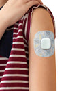 Kid wearing Simplera Sensor Patch with animal design on arm.