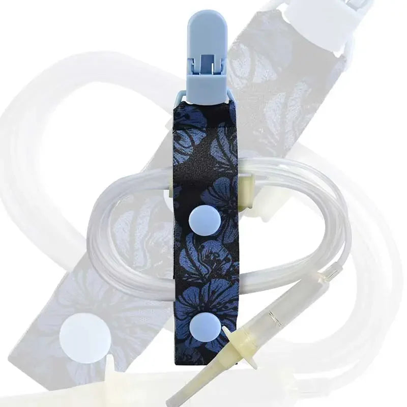 Kaio-Tube Clip with blue floral fabric and light blue buttons, securing medical tubing for organized and comfortable wear. Image