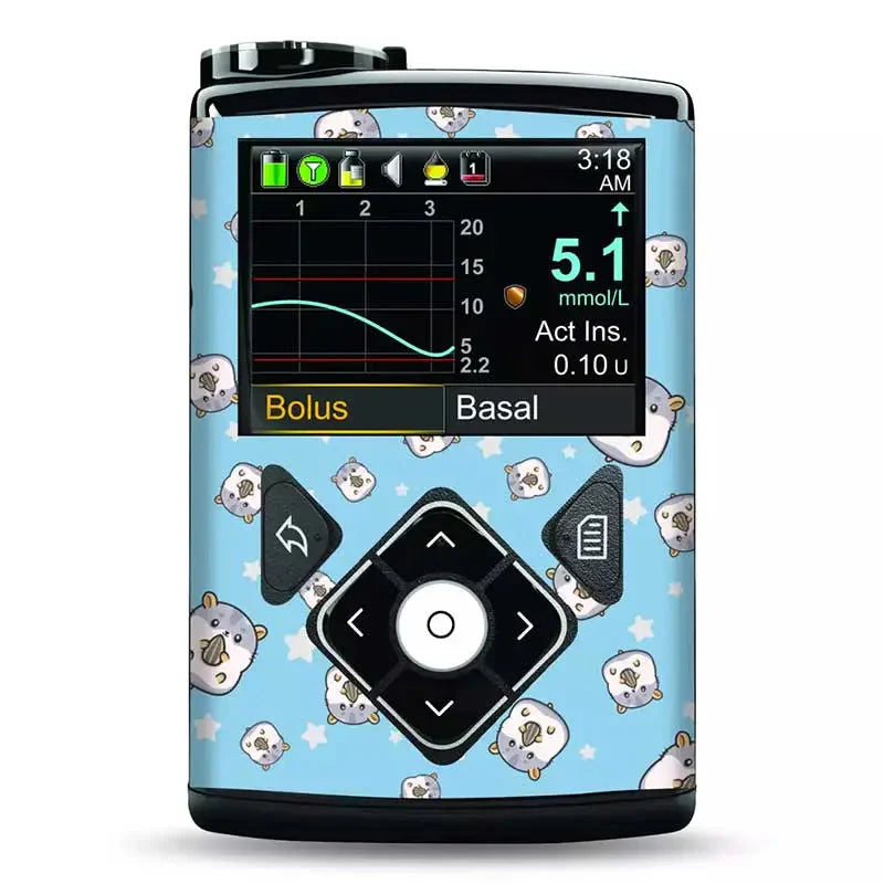 Medtronic Minimed insulin pump adorned with a blue vinyl sticker featuring cute, small animal faces and stars. The device screen displays glucose monitoring data. Image