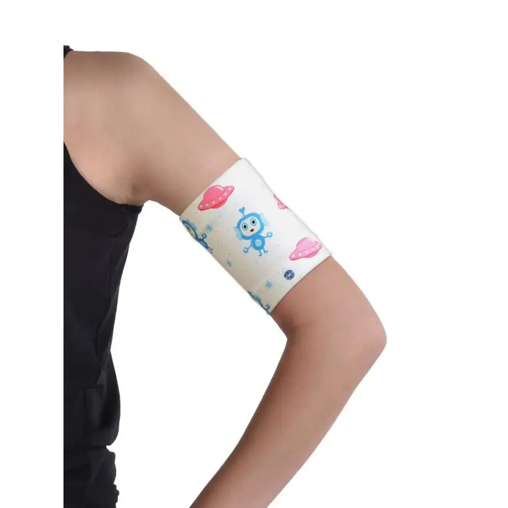 Child wearing Dia-Band armband for protecting blood glucose sensor, displaying playful pattern and secure fit.