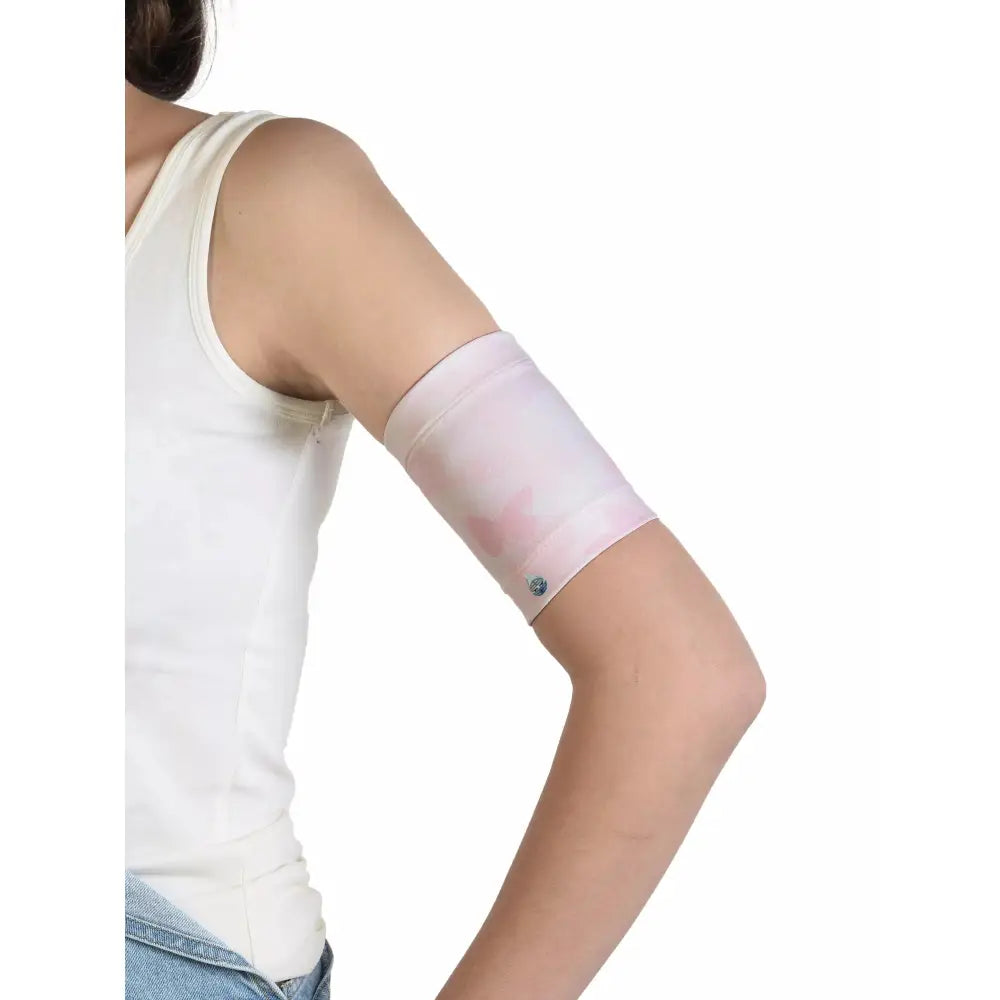 Child wearing a Dia-Band armband for securing a blood glucose sensor, designed for kids with trendy patterns and durable fabric.