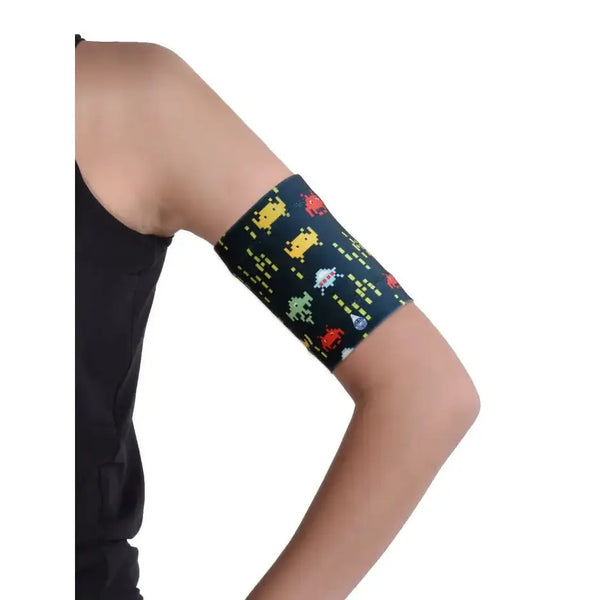 Colorful armband for children's blood glucose sensor with trendy prints, ensuring secure fit and comfort.