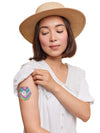 FreeStyle Libre 3 hexagonal shape patch worn on a woman’s arm, with breathable adhesive fabric for sensor support