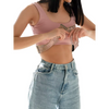 Insulin pump belt in lace being adjusted on a person wearing a pink top and jeans.