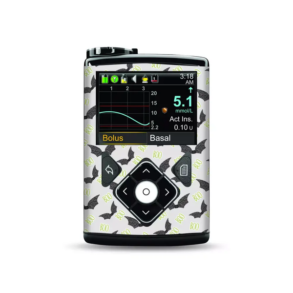 Medtronic MiniMed insulin pump with Halloween-themed stickers featuring bats and "boo" text.