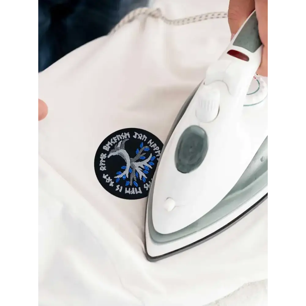 Viking-inspired embroidered diabetes awareness iron-on patch being applied to fabric.