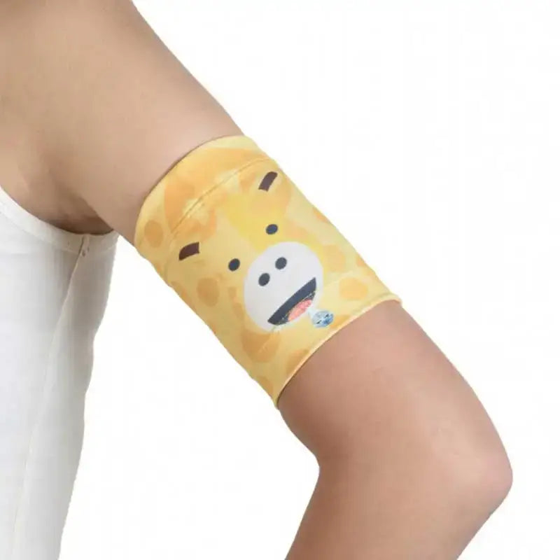 Blood Glucose Sensor Armband for Children - Fauna & Flora design, featuring a yellow giraffe print, worn on a child's arm.